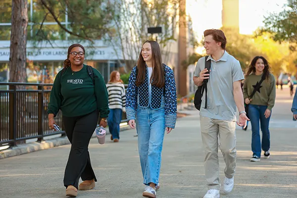 five students walking next to each other