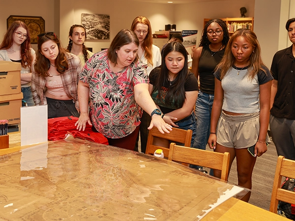 A teacher showing her class a map.