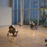 Several metal statues on the floor, sharp angles and shapes 