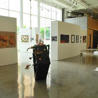 An empty art gallery, several sculptures on the floor 