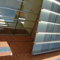 A brick building with tall glass windows 