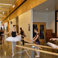 Ballerinas stretching in a hallway