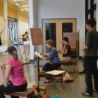 Ballerinas posing as students sketch them 