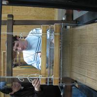 A student and worker at a loom 