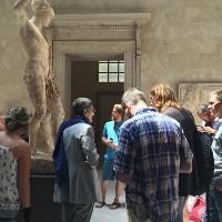 Onlookers next to a statue 