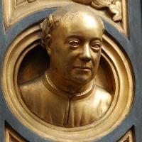 A gold bust of an older man 