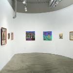 A room with various painting hanging on the wall