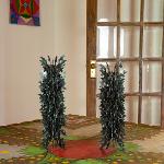 Two tall spiky metal sculptures standing in doorway of Pasaquan building
