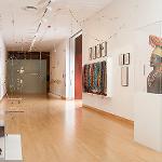 Gallery interior with hanging installations and artwork on walls