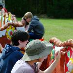 Group of people collaborating on a colorful outdoor mural.