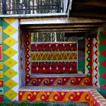 Colorful painted passageway with geometric patterns viewed through aligned doorways