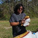 Charles Fowler repairing a painted concrete wall at Pasaquan