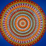 Large colorful concentric circle medallion with geometric patterns on a blue wall