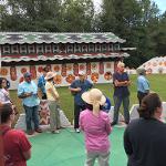 Visitors gathered around the painted courtyard during a guided tour at Pasaquan