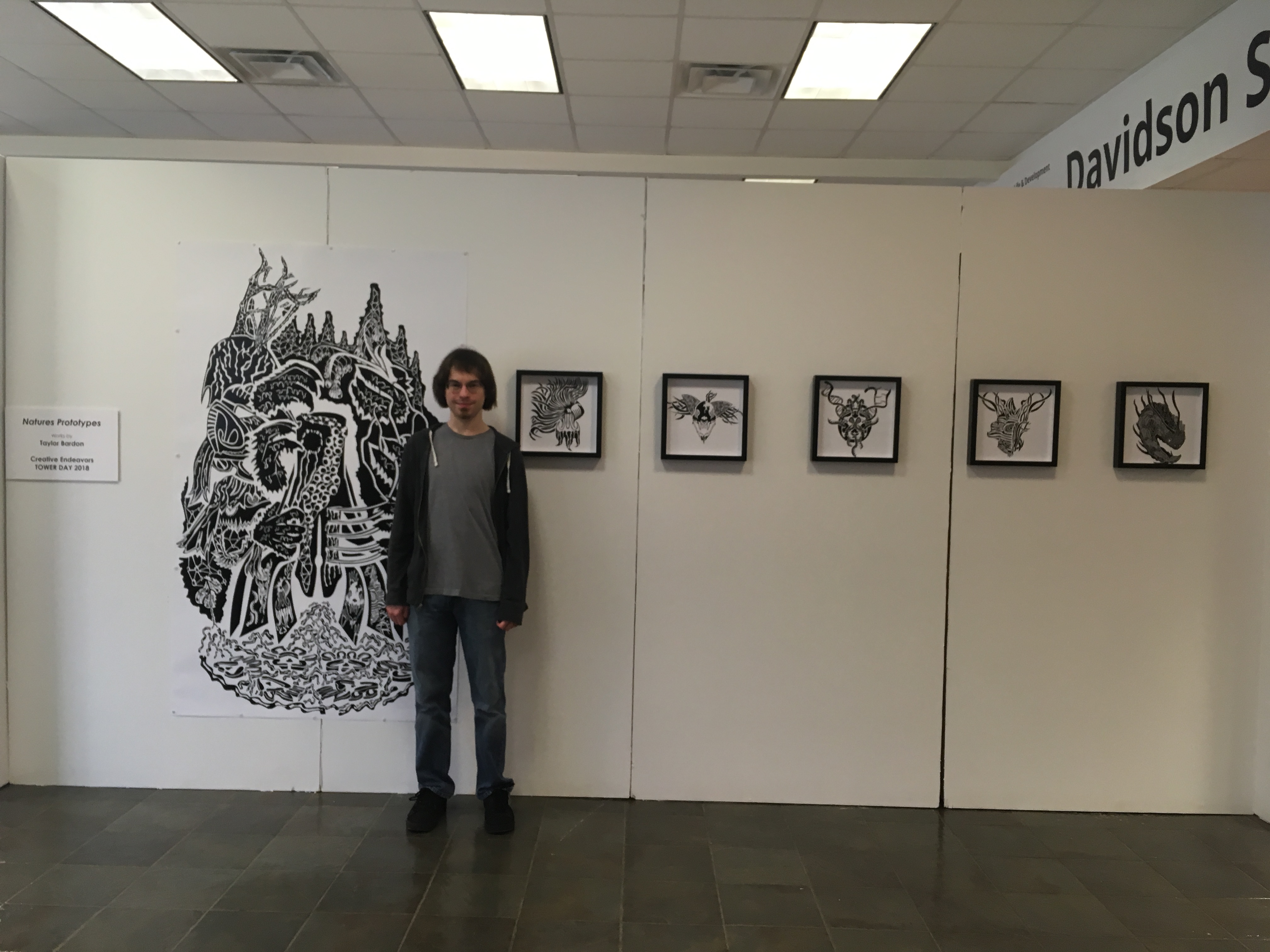 a student standing in front of a wall