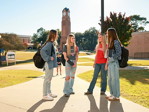 Students talking happily by the CSU clocktower