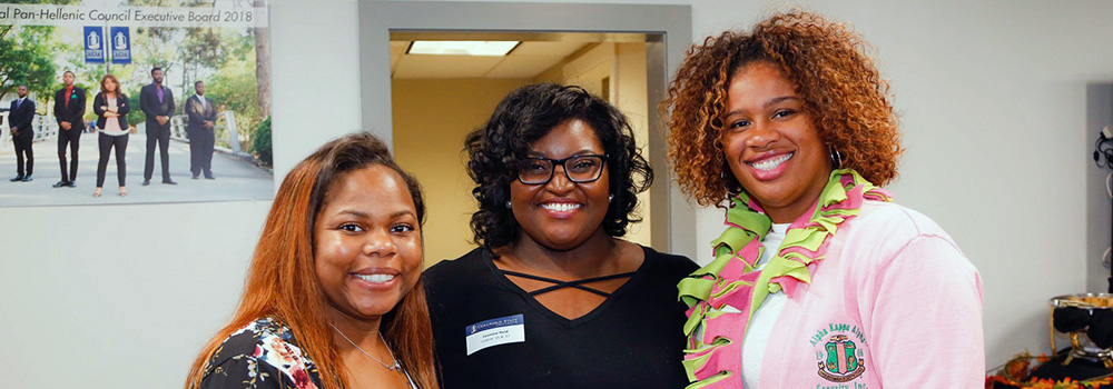 three women smiling and posing for the camera