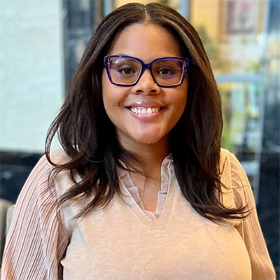 a woman with glasses posing for the camera