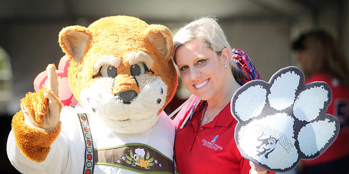a woman wearing a red CSU shirt and Cody the Cougar