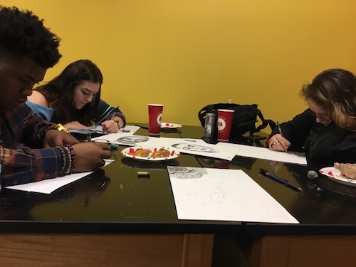 Two students in art lab drawing