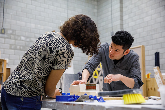 a professor helping a student with a project