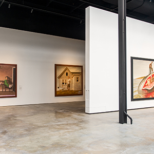 two walls with several paintings on them