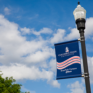 a lamppost with a Columbus State University banner on it