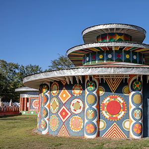 a circular building with several artistic motifs on it
