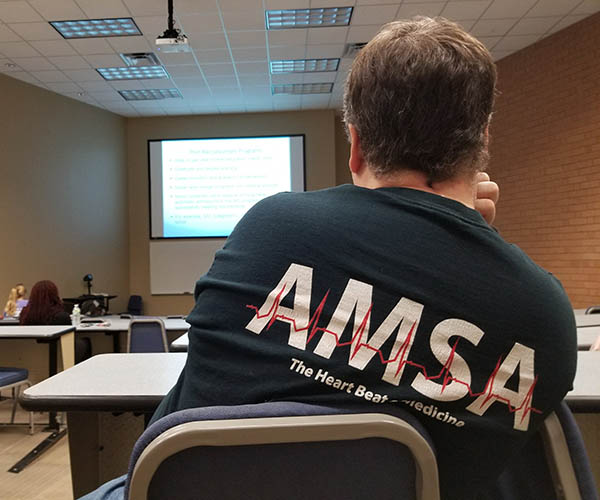 A student sitting watching a presentation