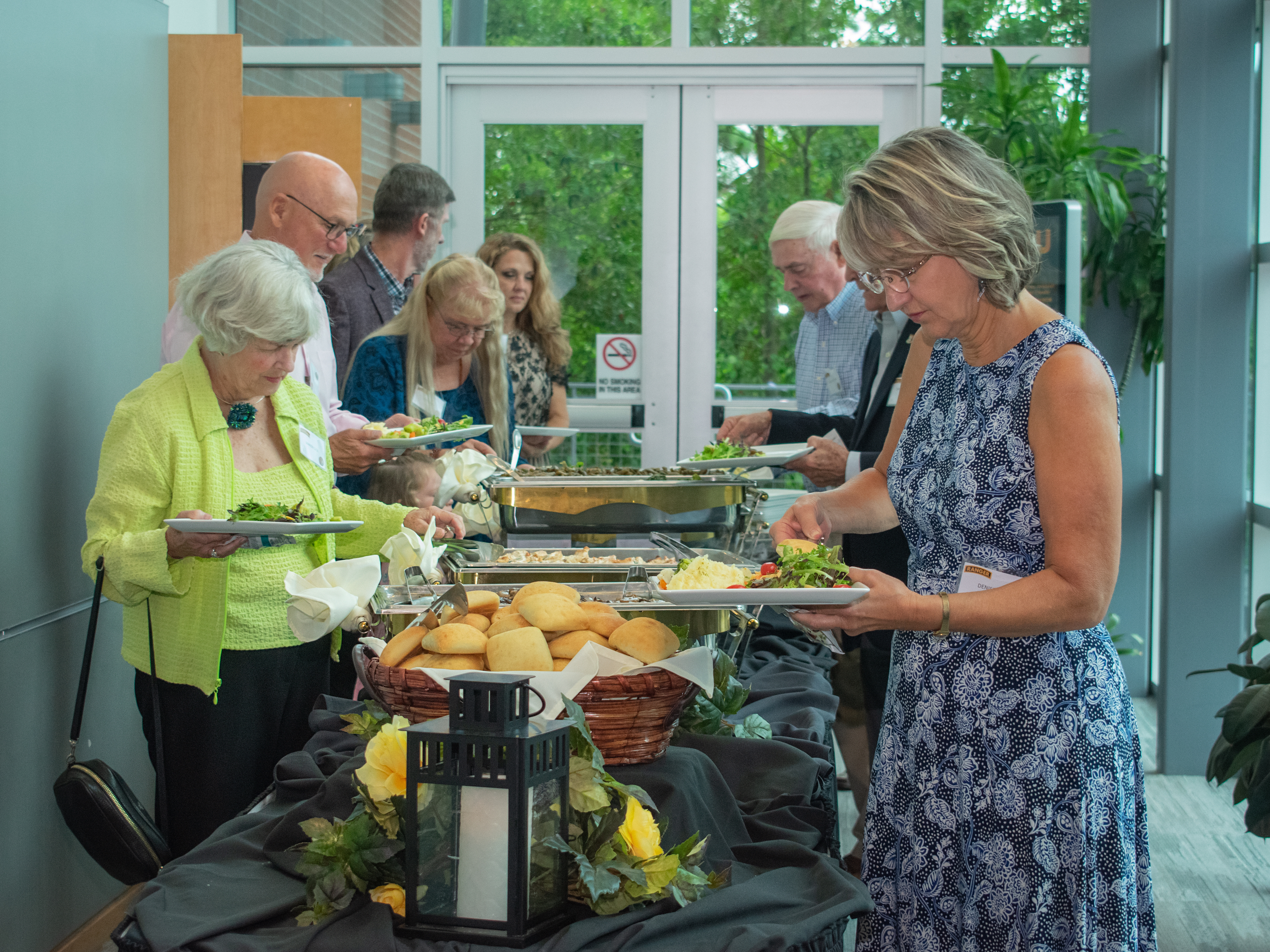 People in line getting plates of food