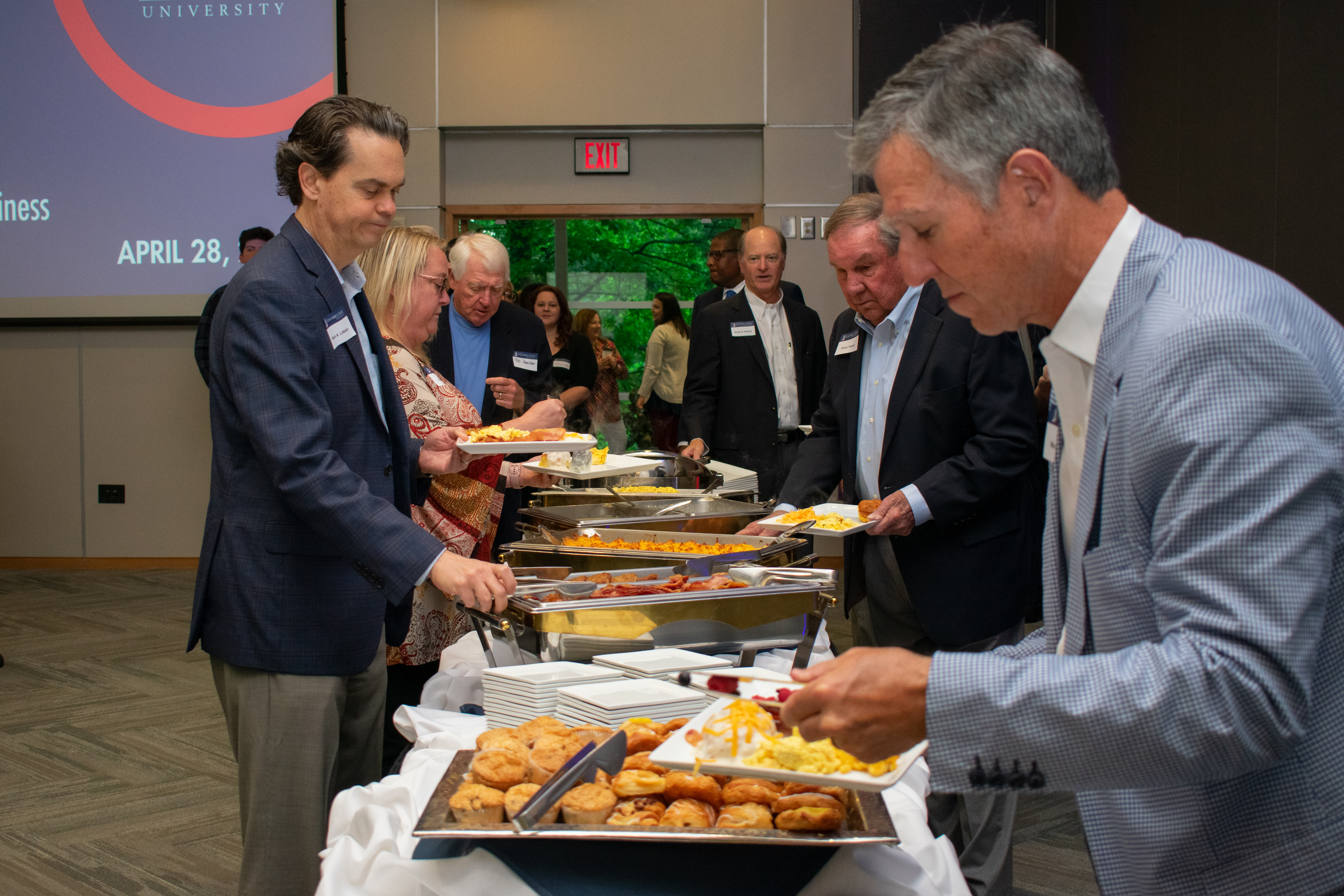 People in line getting plates of food