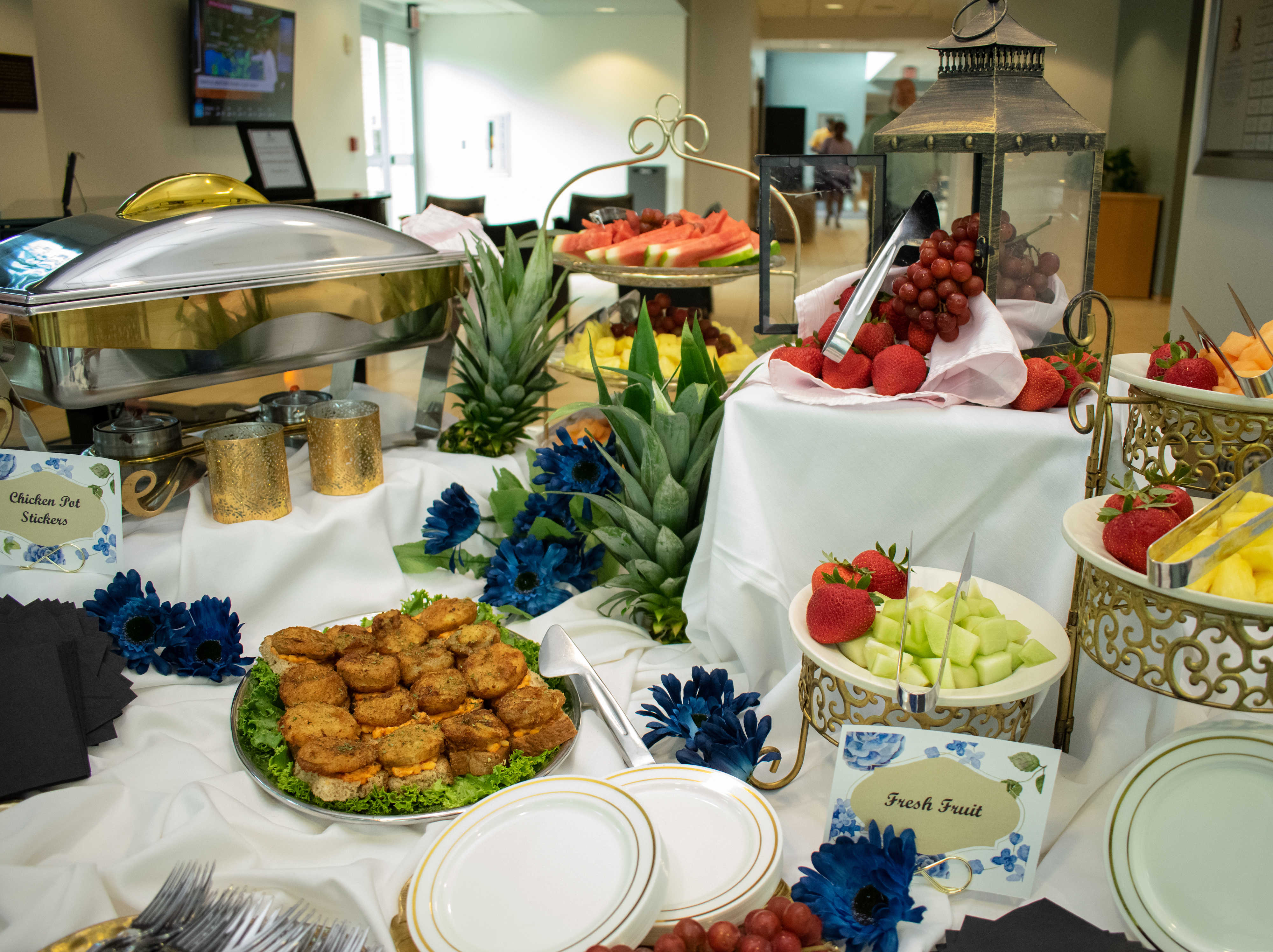 Table with fruits and mini sandwiches