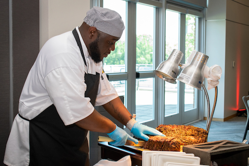a person holding plates of food