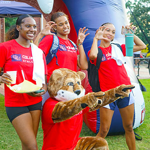 Students posing with Cody at an outdoor kickoff event