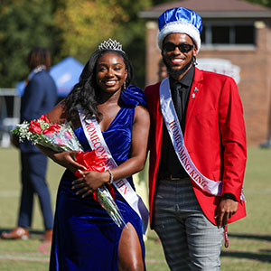 Homecoming king and queen on the field in formal attire