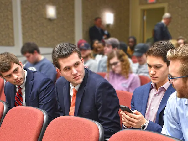 Students in an auditorium listening to a speaker