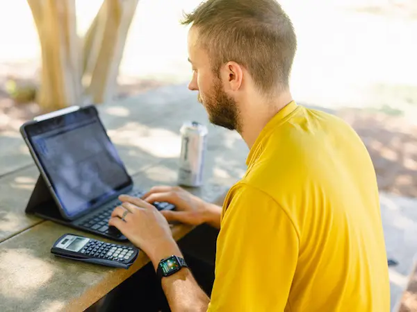 A student sitting at their laptop