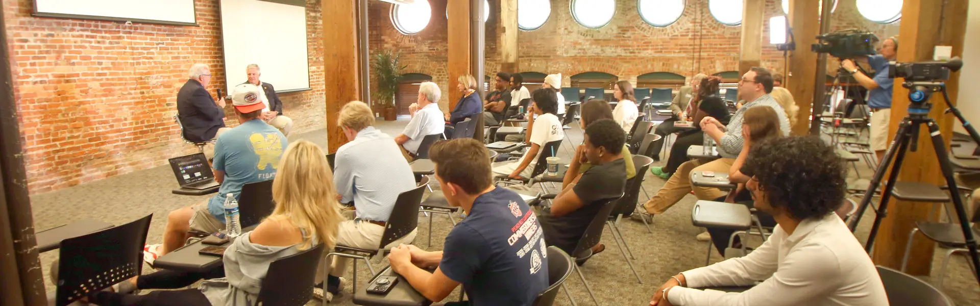 Students watching a live interview Chuck Williams and Drew Ferguson being taped