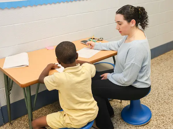 A teacher instructing a student