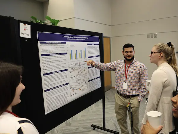 a student presenting his data to a group of people