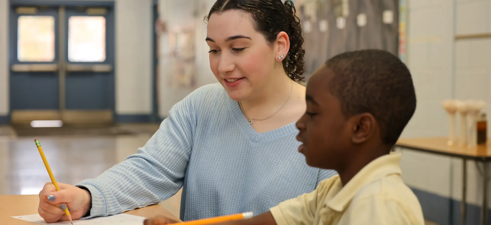 teacher and student sitting at a table