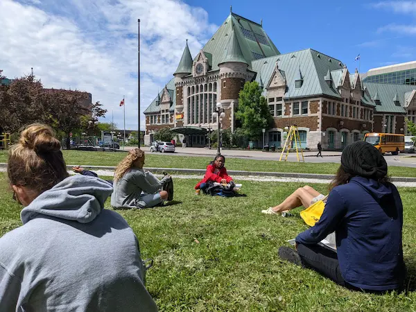 Students sitting on a lawn in Canada
