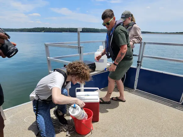 students on a boat doing research in the ocean