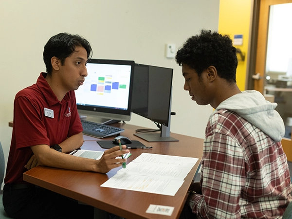 A student being tutored by a mentor.