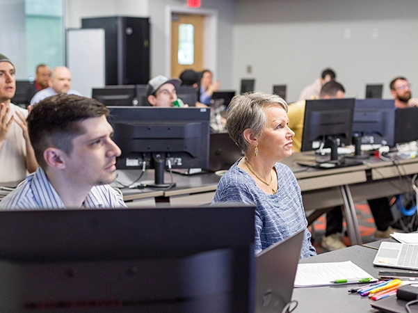 Students in a computer science classroom learning about Information Technology