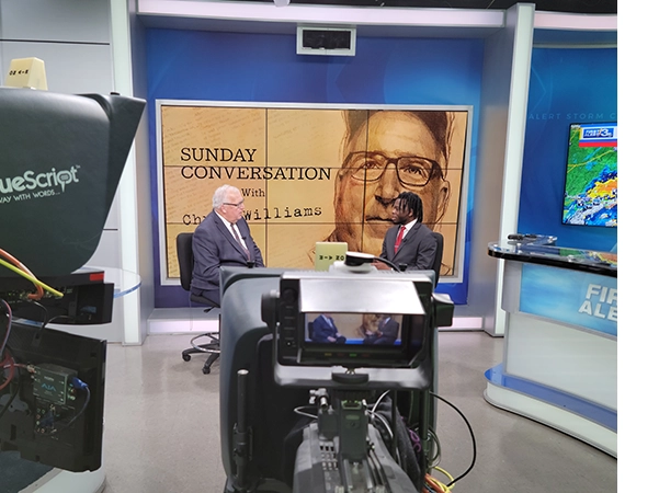 An interview being held with a student in a large studio area.