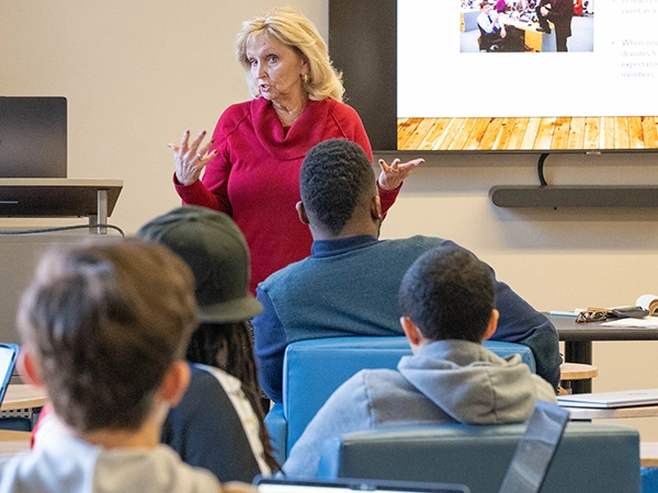 A professor giving a presentation and lecture to her class.
