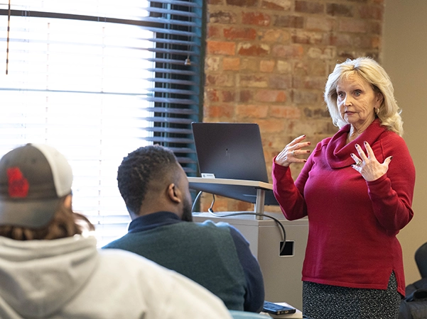 A professor teaching and lecturing to her class.