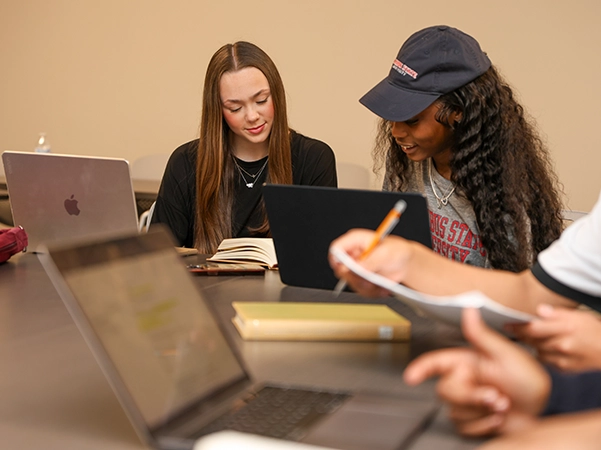 Two students studying reading notes and studying together.