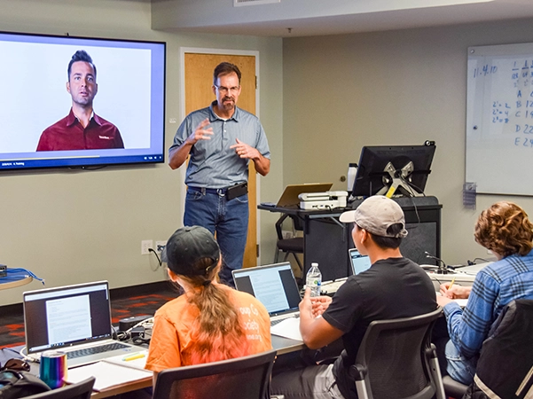 A professor showing a video to his class.